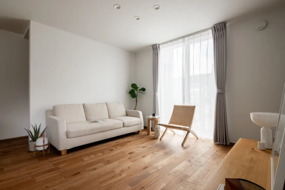 大きな窓から柔らかな光が差し込む明るいリビング